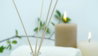 white pillar candle on silver holder